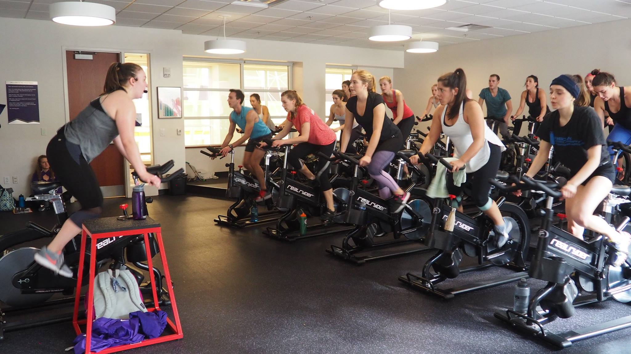 A group of people do a workout on stationary bikes