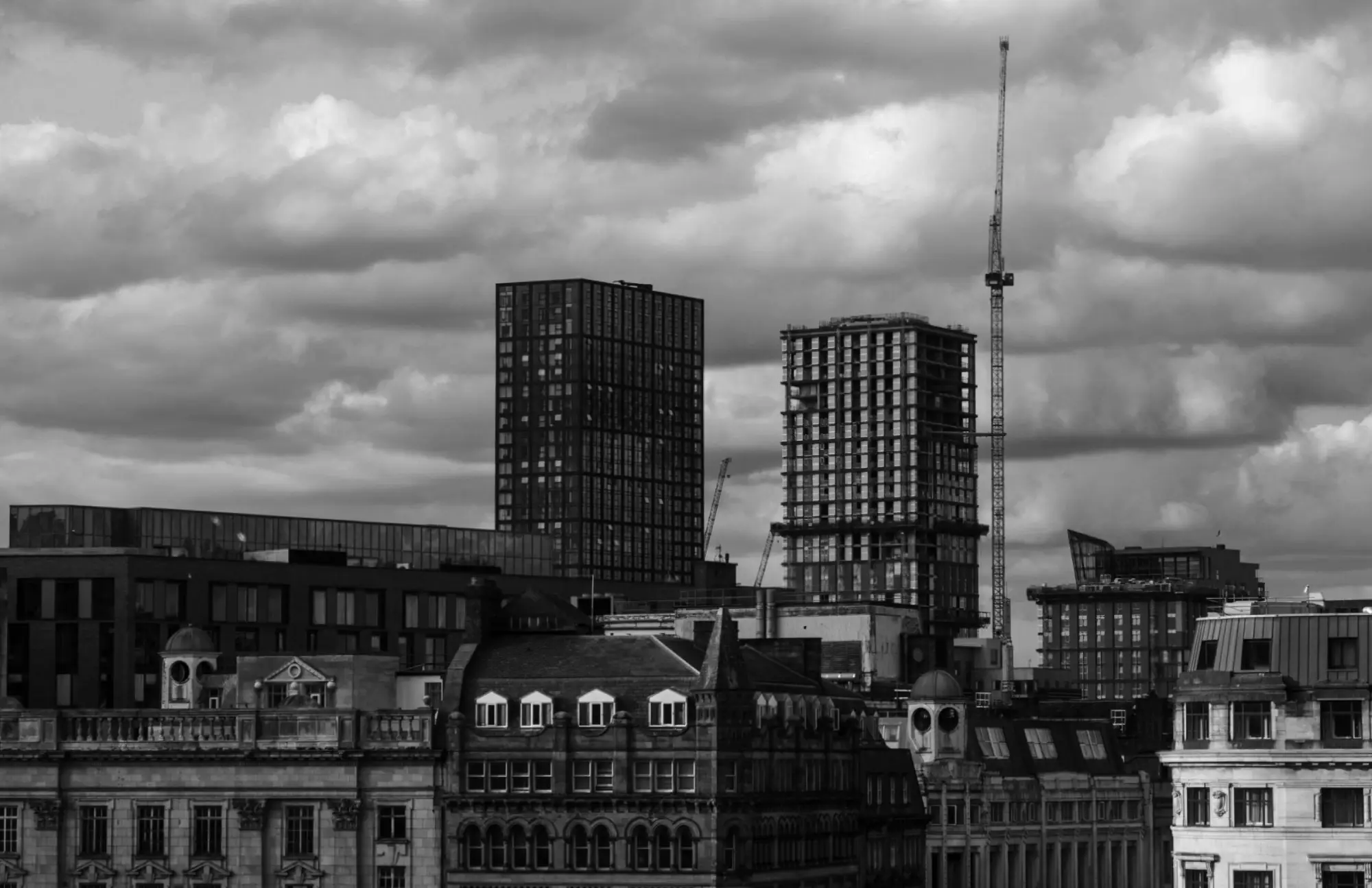 Manchester cityscape featuring historic buildings in the foreground and modern high-rises