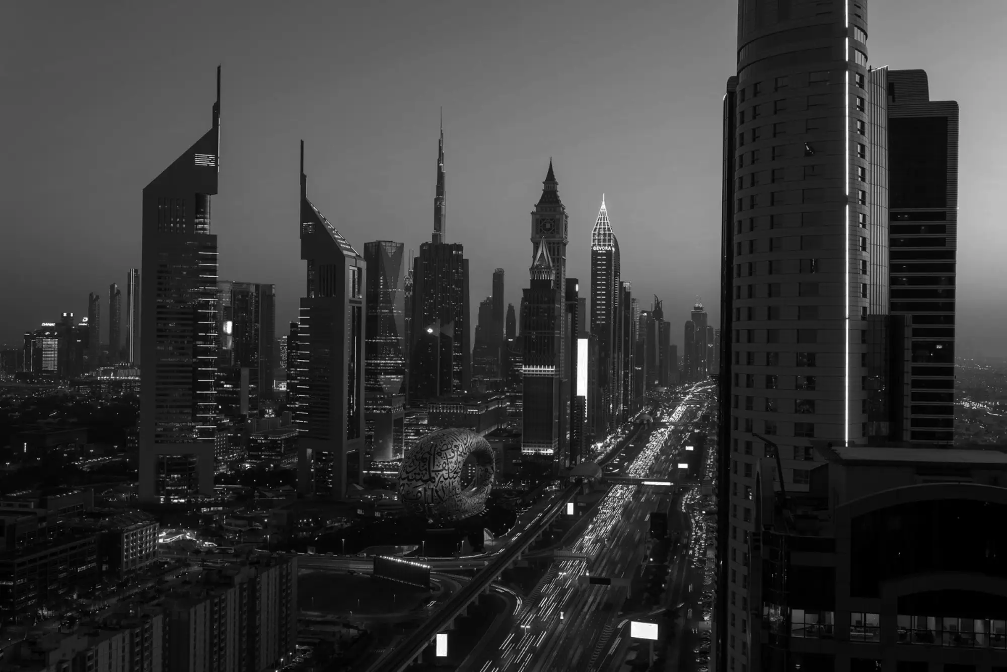 Nighttime view of Dubai’s skyline featuring Burj Khalifa, Museum of the Future, and light trails