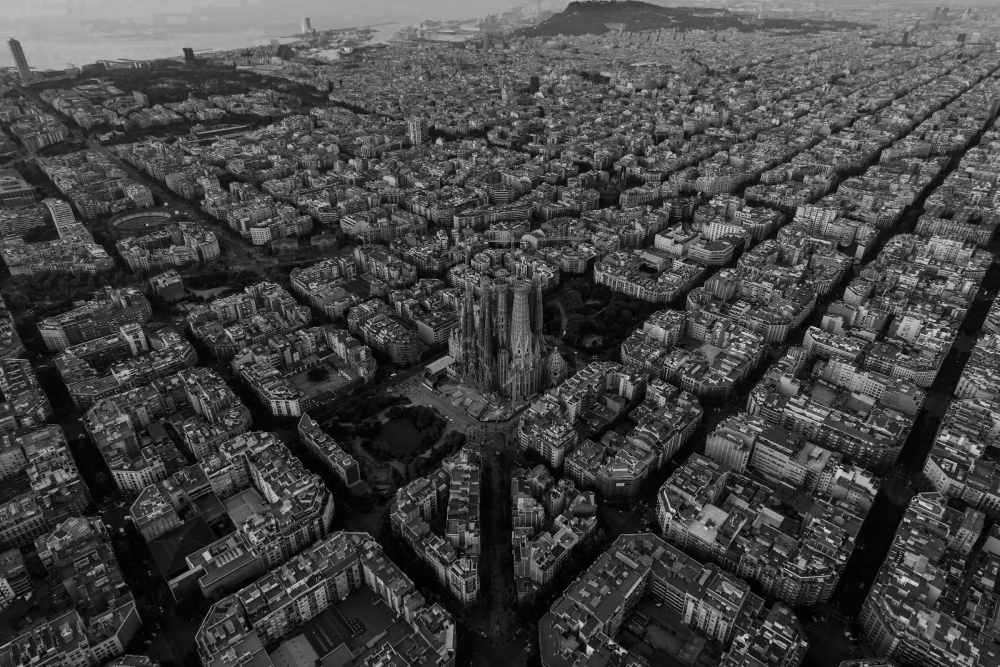 Aerial view of Barcelona featuring the Sagrada Família and the city's grid-like layout