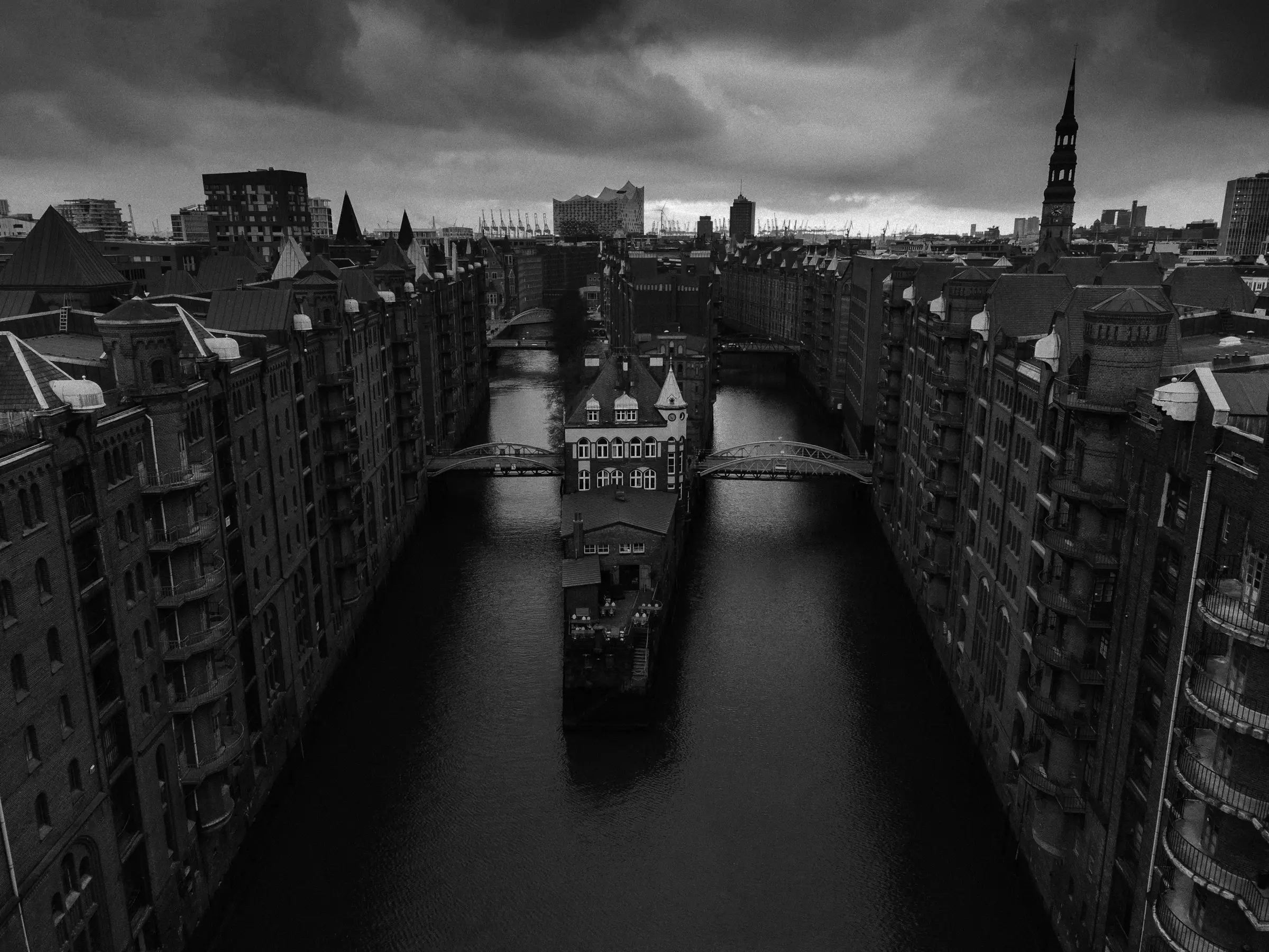 Aerial view of Hamburg's Speicherstadt with red-brick warehouses lining a canal