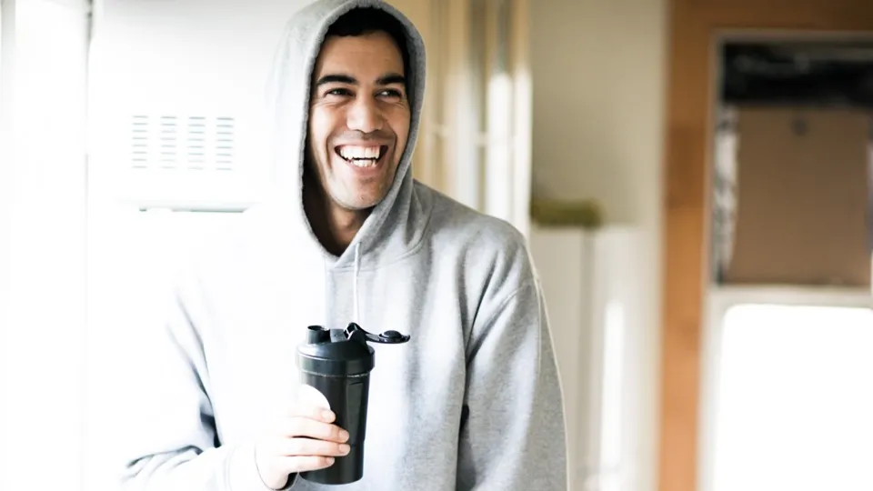 Person holding a protein shake drink