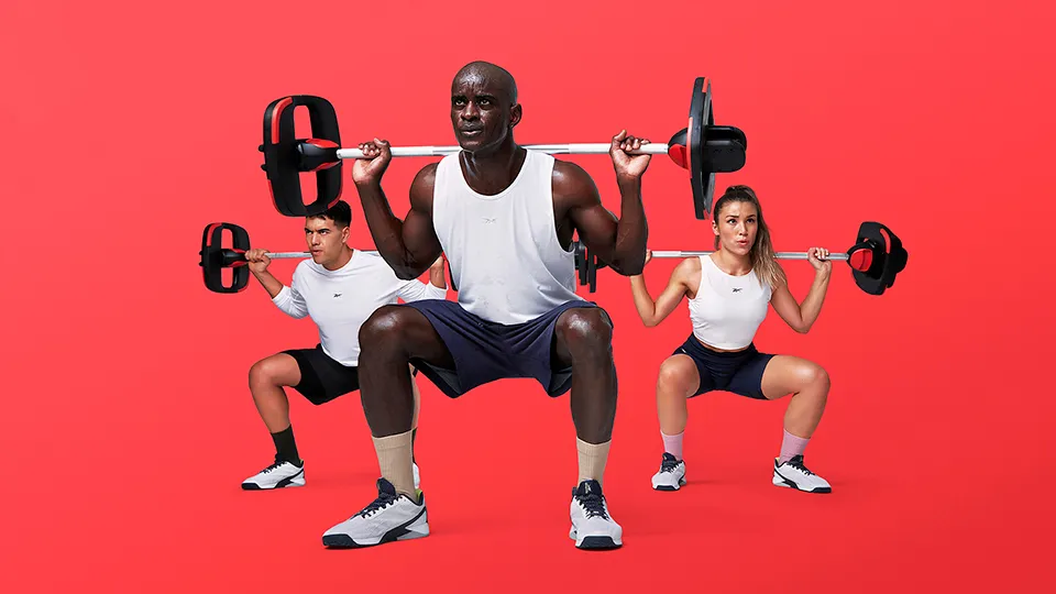 Three people lifting a Smartbar