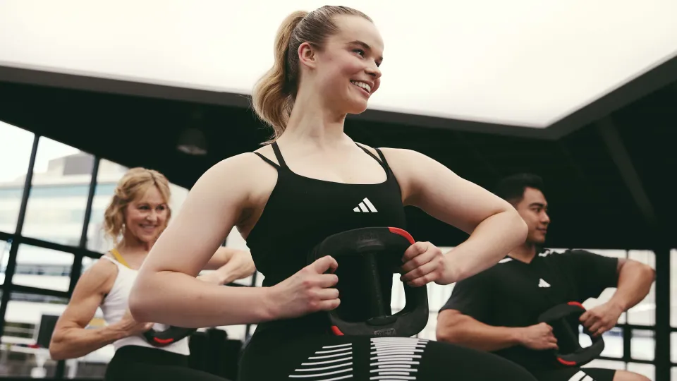 Les Mills Instructors holding smartbar plates