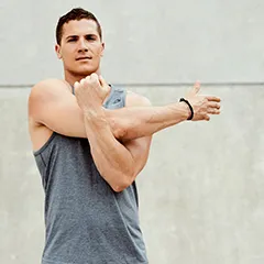 man stretching sholders and deltoids with good form