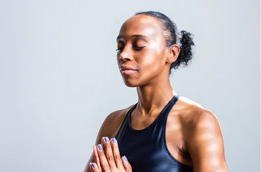 Woman with eyes closed doing mindfulness exercise