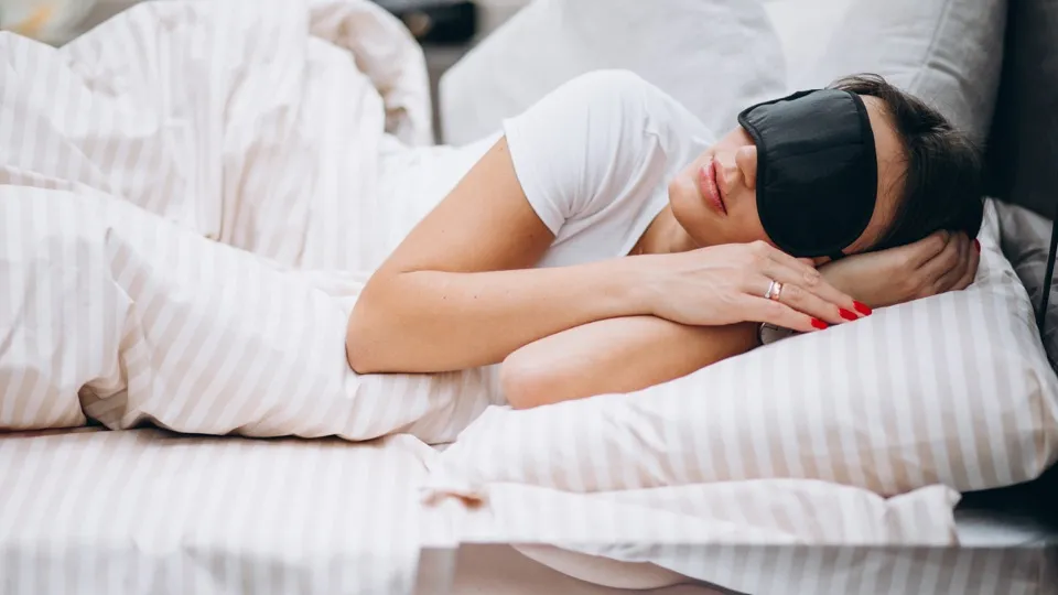 a woman sleeping wearing an eye mask