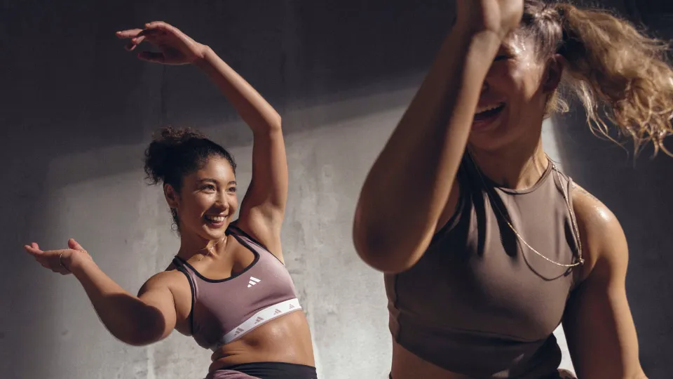 Two people dancing with arms raised