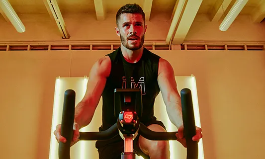 a man riding a spin bike