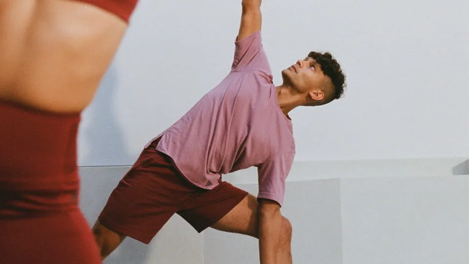 Person in pink athletic outfit performing a side angle yoga pose