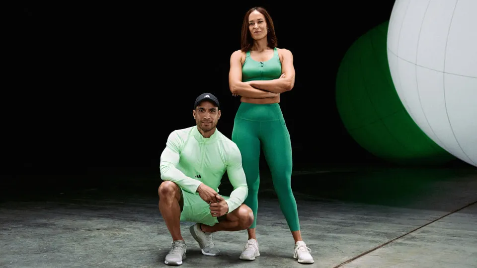 two people in a pose wearing green sports wear