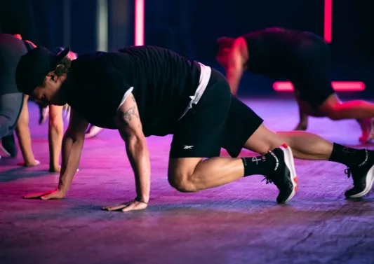 a group fitness class performing mountain climbing