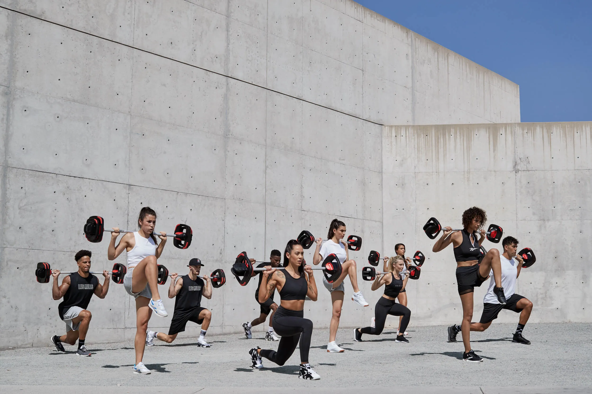 group of people performing fitness class with smartbar