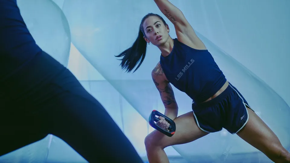 People in athletic gear performing extended stretch