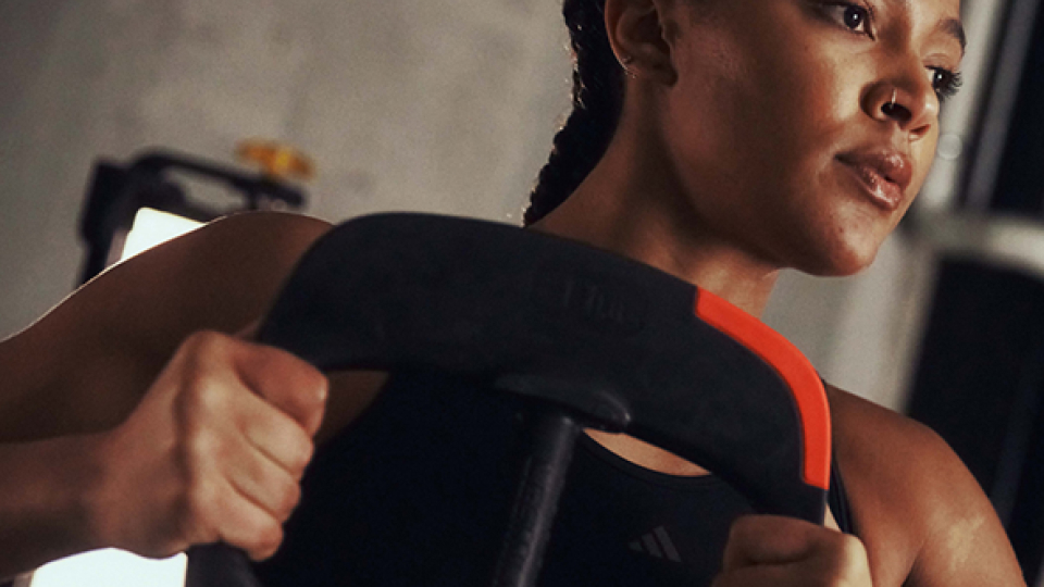 A woman exercising by lifting a weight plate 
