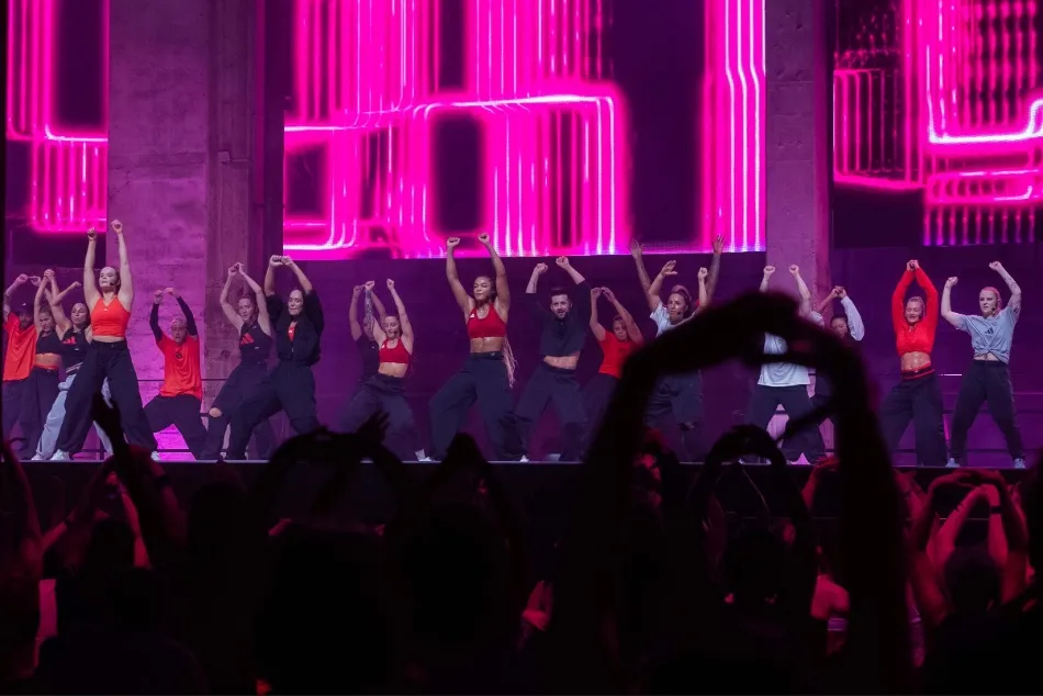 Les Mills Instructors lead a group workout to a large audience