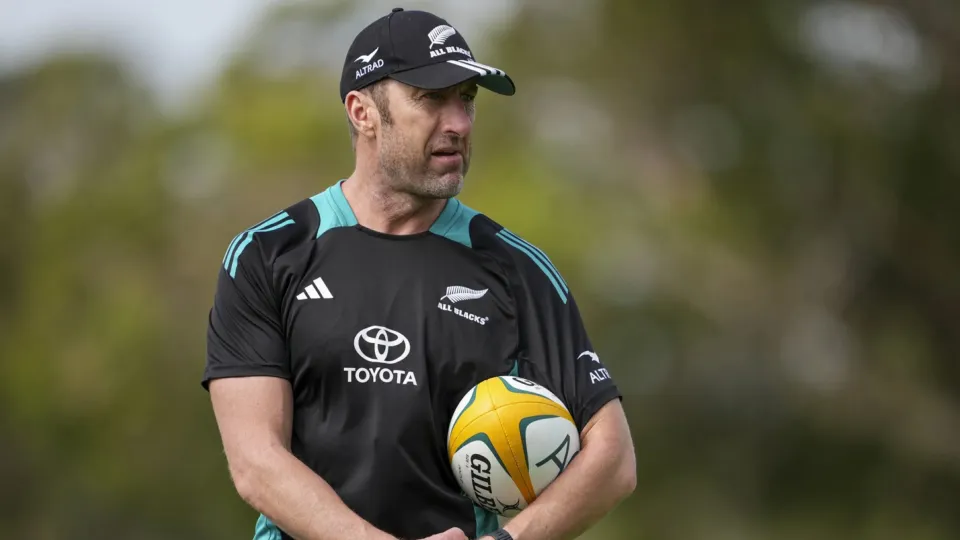 A man sideline with a rugby ball