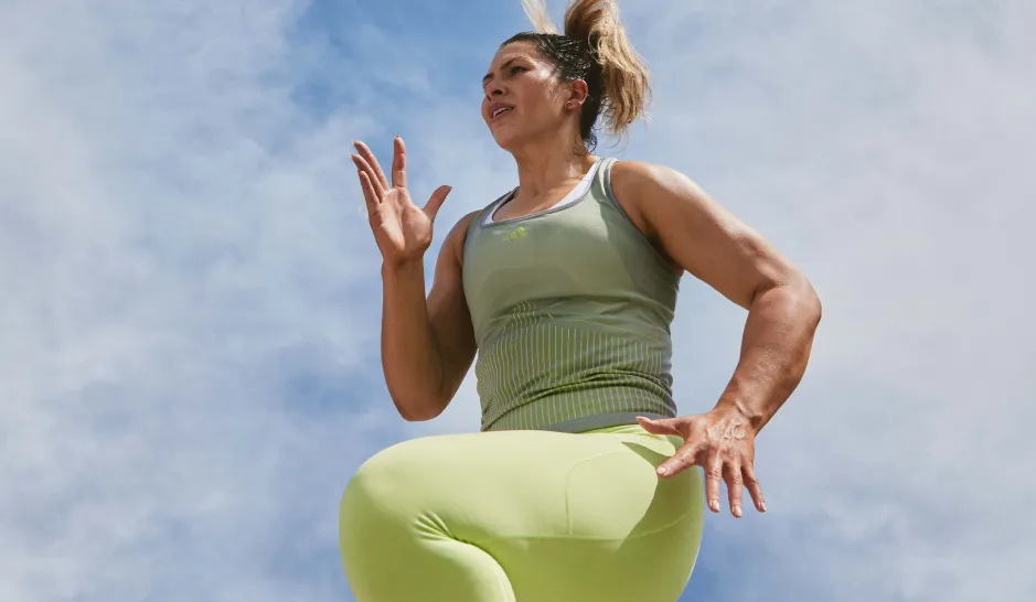 A woman in fitness gear running outside