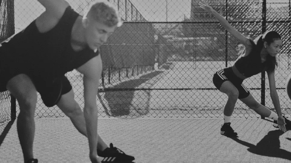 A man and women doing a HIIT workout outside