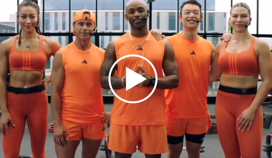 A group of fitness instructors in orange