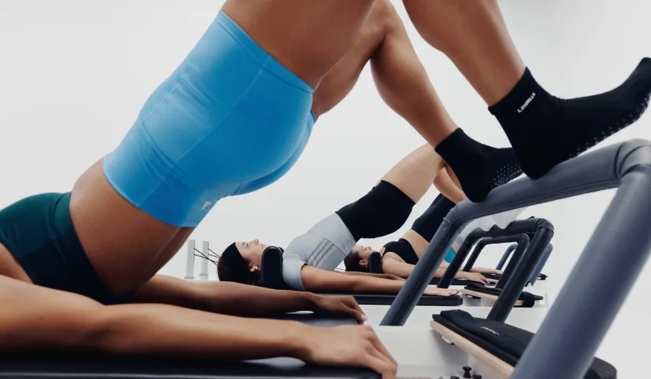 Toes on bar on a Pilates Reformer machine