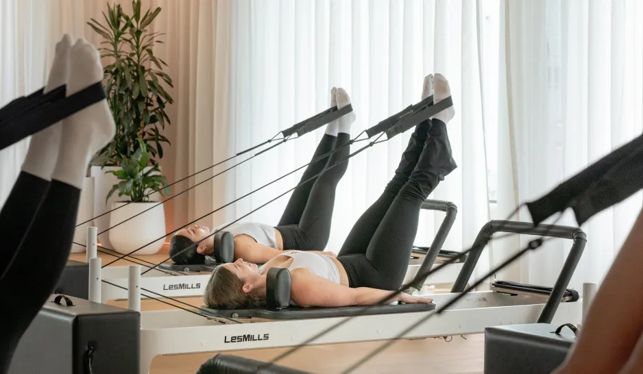 Feet in straps during a LES MILLS REFORMER class