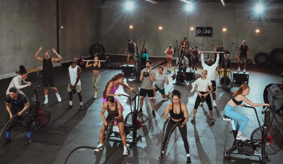 Exercisers in a busy CEREMONY HYROX circuit workout
