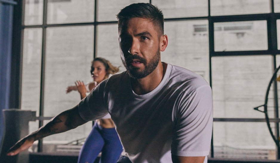 A man and a woman moving in sync in a group workout
