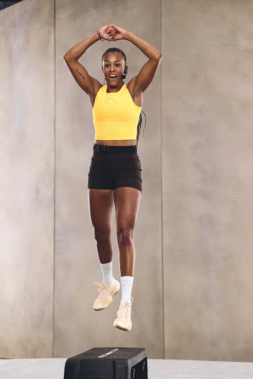 Les Mills Instructor jumps high over Les Mills step