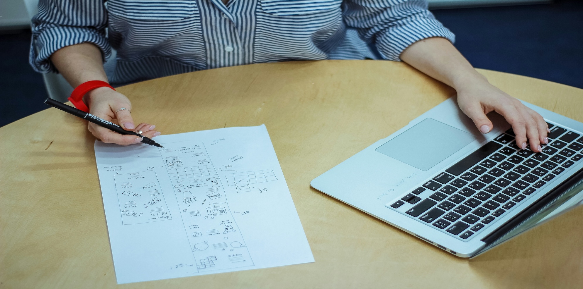Australian small business owner reviewing administrative systems on computer with organised paperwork and business documents on modern office desk