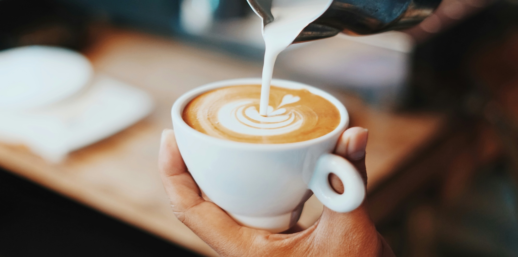 Cartoon illustration of a team of 15 Aussies queuing for coffee with coffee cups turning into dollar signs evaporating into the air, symbolising productivity loss for small businesses in 2025, complete with a steaming flat white and Aussie icons like a kangaroo in the background.
