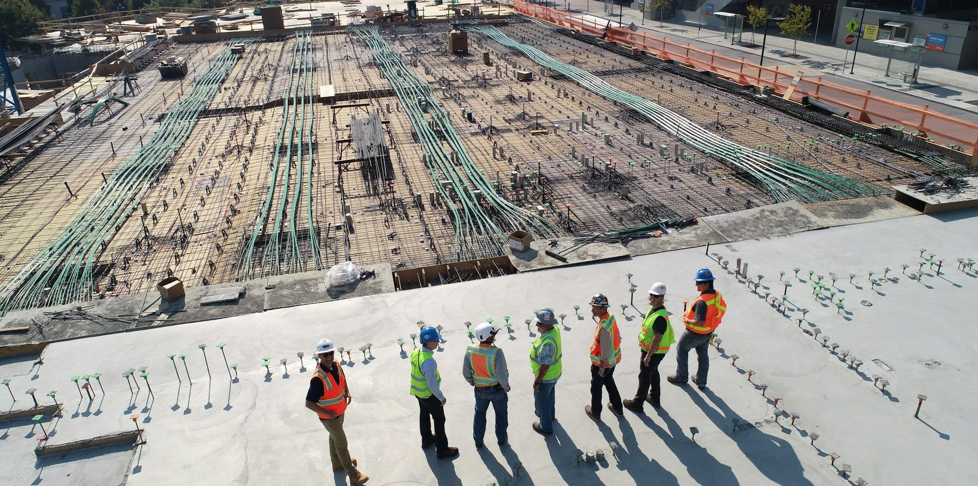 A factory floor with a bill of materials flowing through work in progress stages into a finished product costing worksheet.