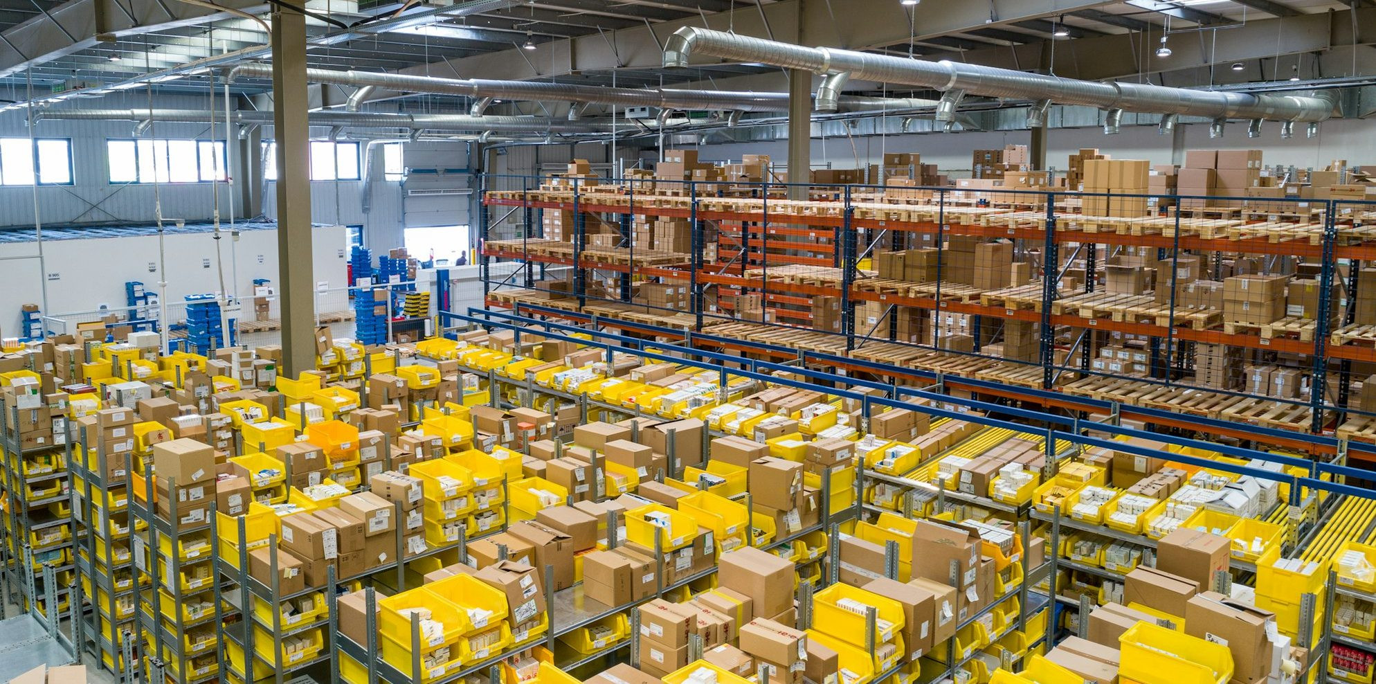 A pharmacy dispensary counter with PBS claim statements reconciling against dispensing records and a stock turn dashboard.