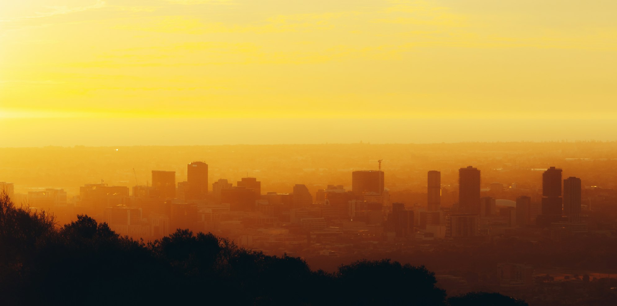 Adelaide city skyline at golden-hour sunset viewed from the Adelaide Hills