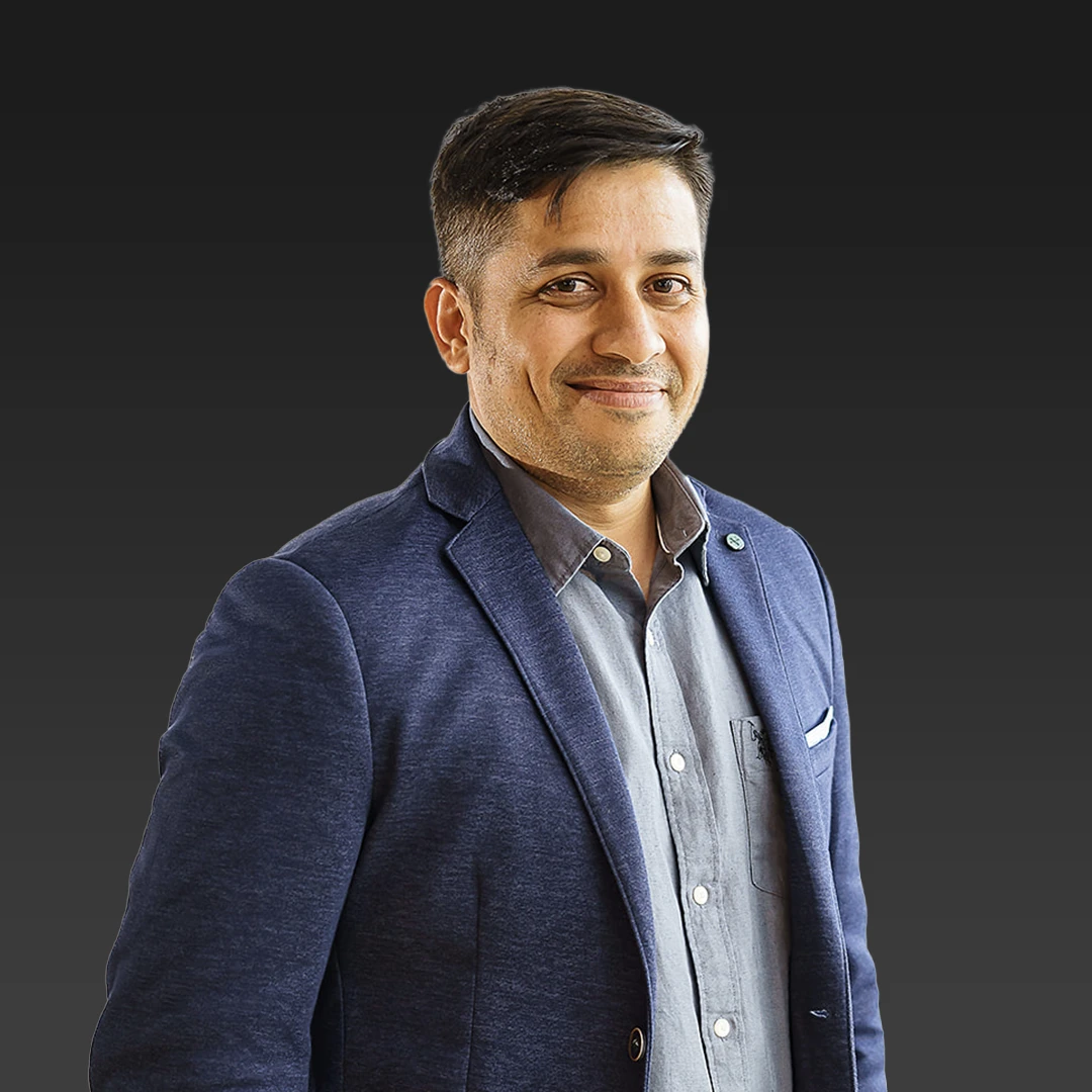 Profile Picture of Kalpesh Patel standing against a dark gradient background.