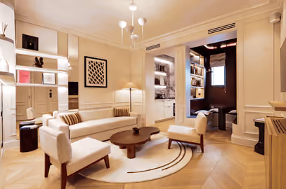 High-end Parisian apartment interior featuring herringbone floors, warm ambient lighting, and minimalist decor.