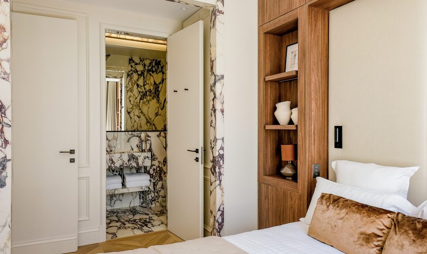 Salle de bain en marbre veiné attenante à une chambre de l'hôtel The Lander