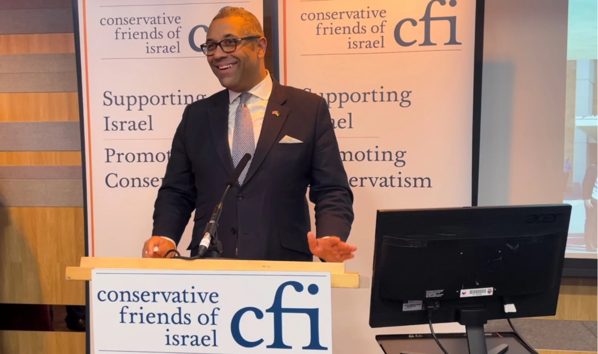 Speaker at Conservative Friends of Israel event gesturing at podium