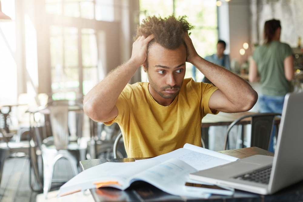 man holding his head - Hardest A Levels