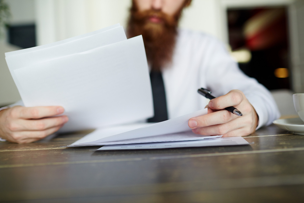 man checking some papers - A Level Grading System