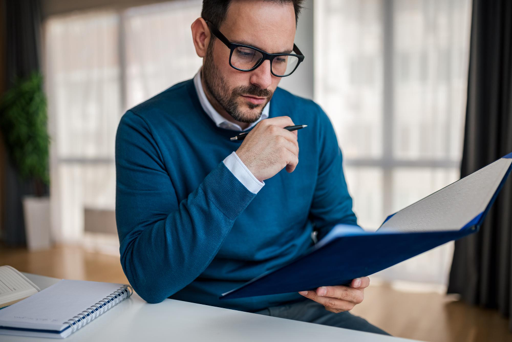 man reading a file - A Level Grading System