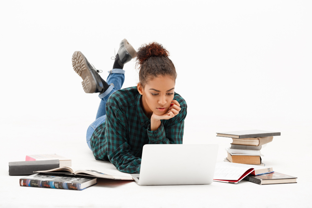 woman lying on the floor with her laptop - Benefits of AI for Students