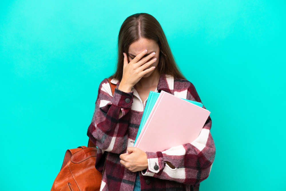 woman with her hand on her forehead - Is Maths A Level Hard