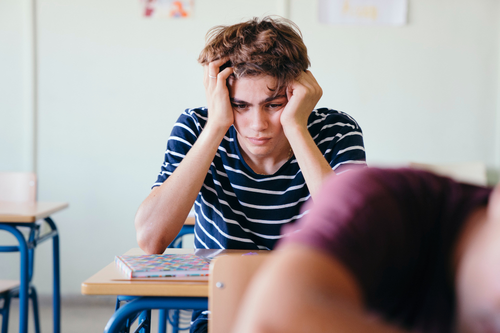 student holding his head with his hands - Is Maths A Level Hard