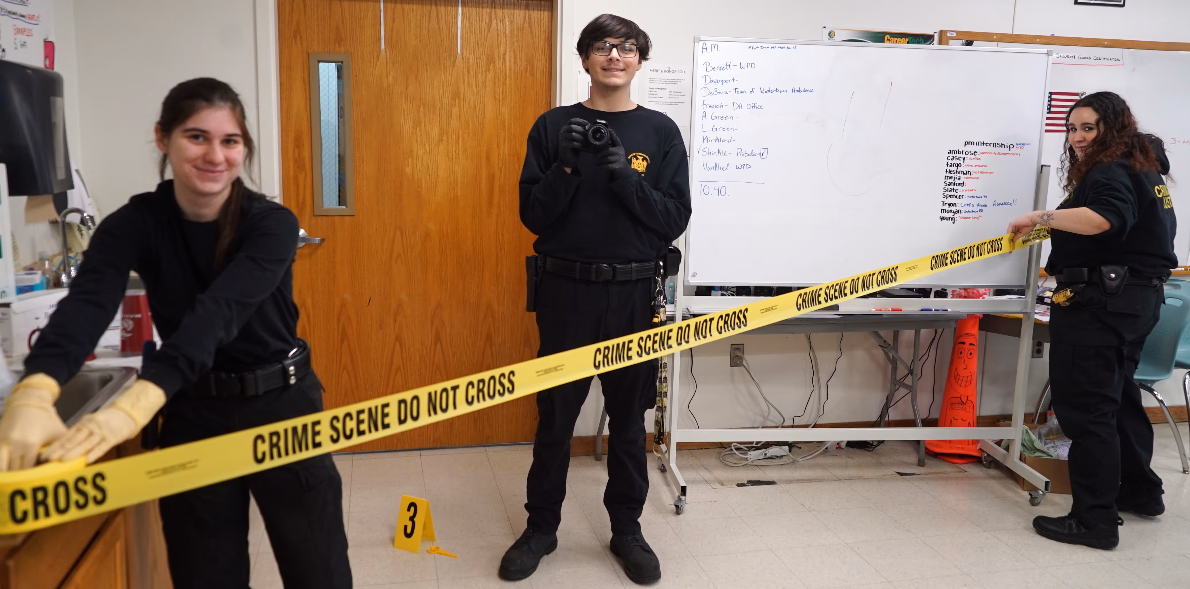 Students putting up crime scene tape.