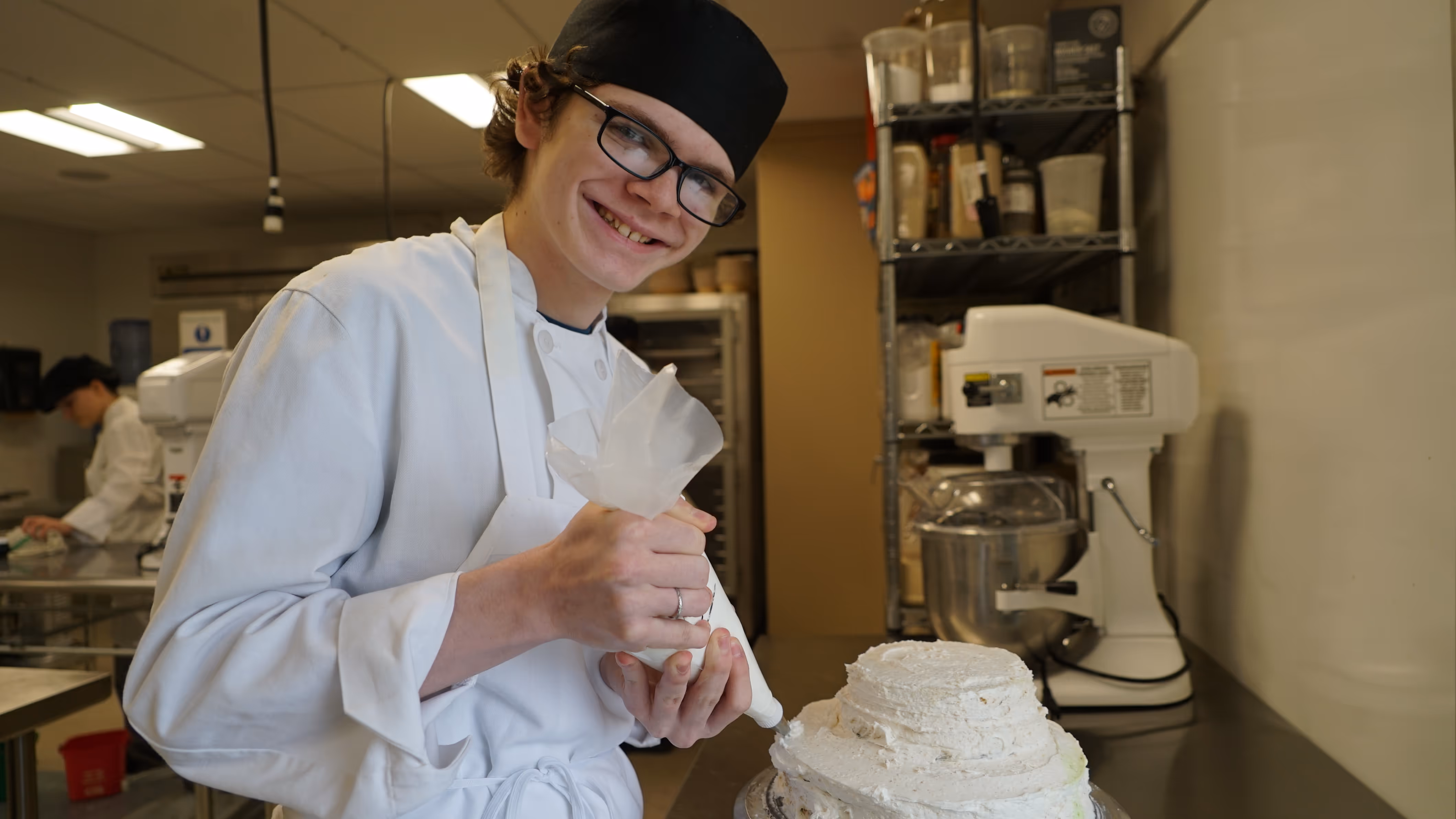 Student decorating cake