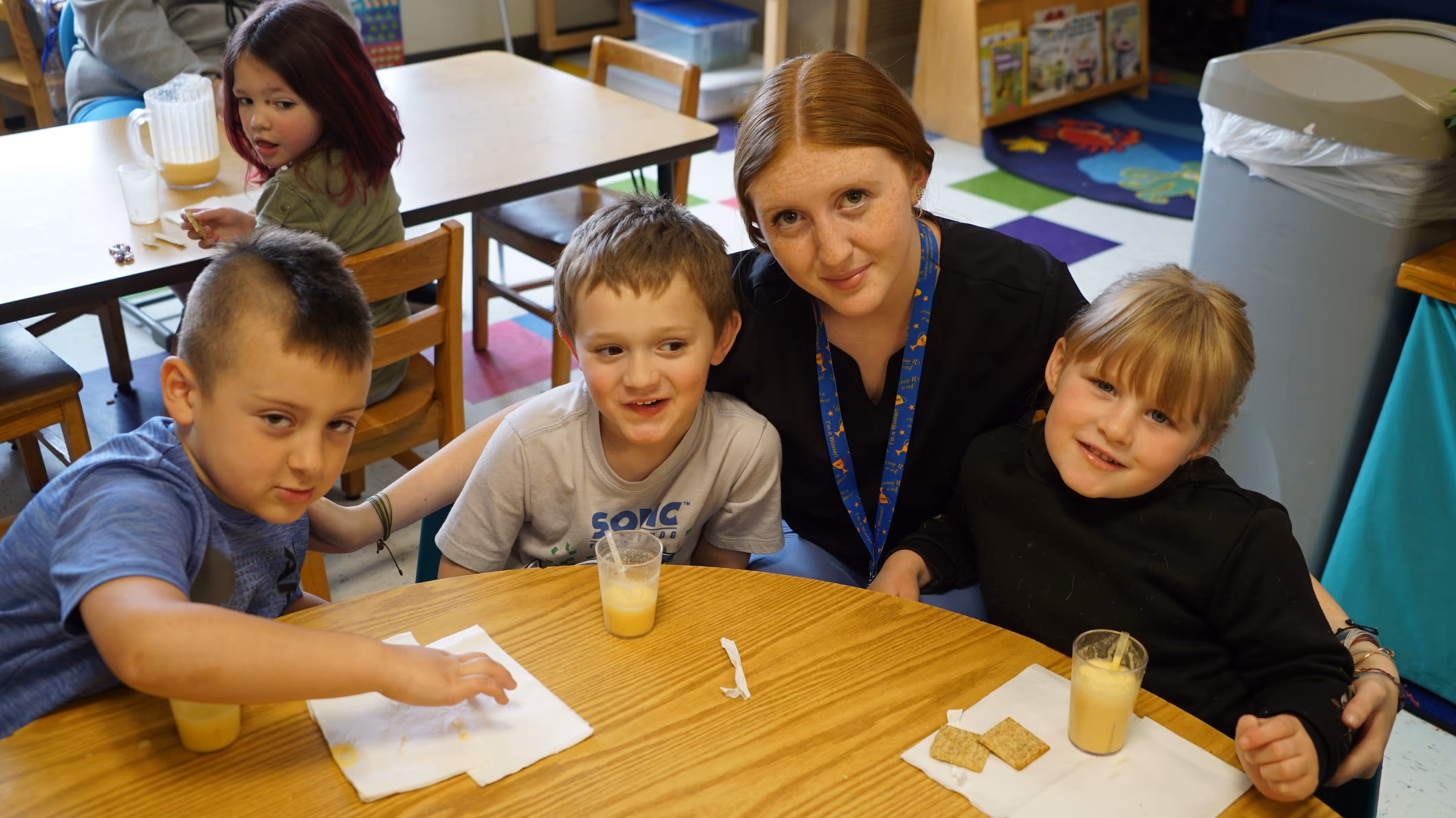 Student working with Pre-K students in classroom.