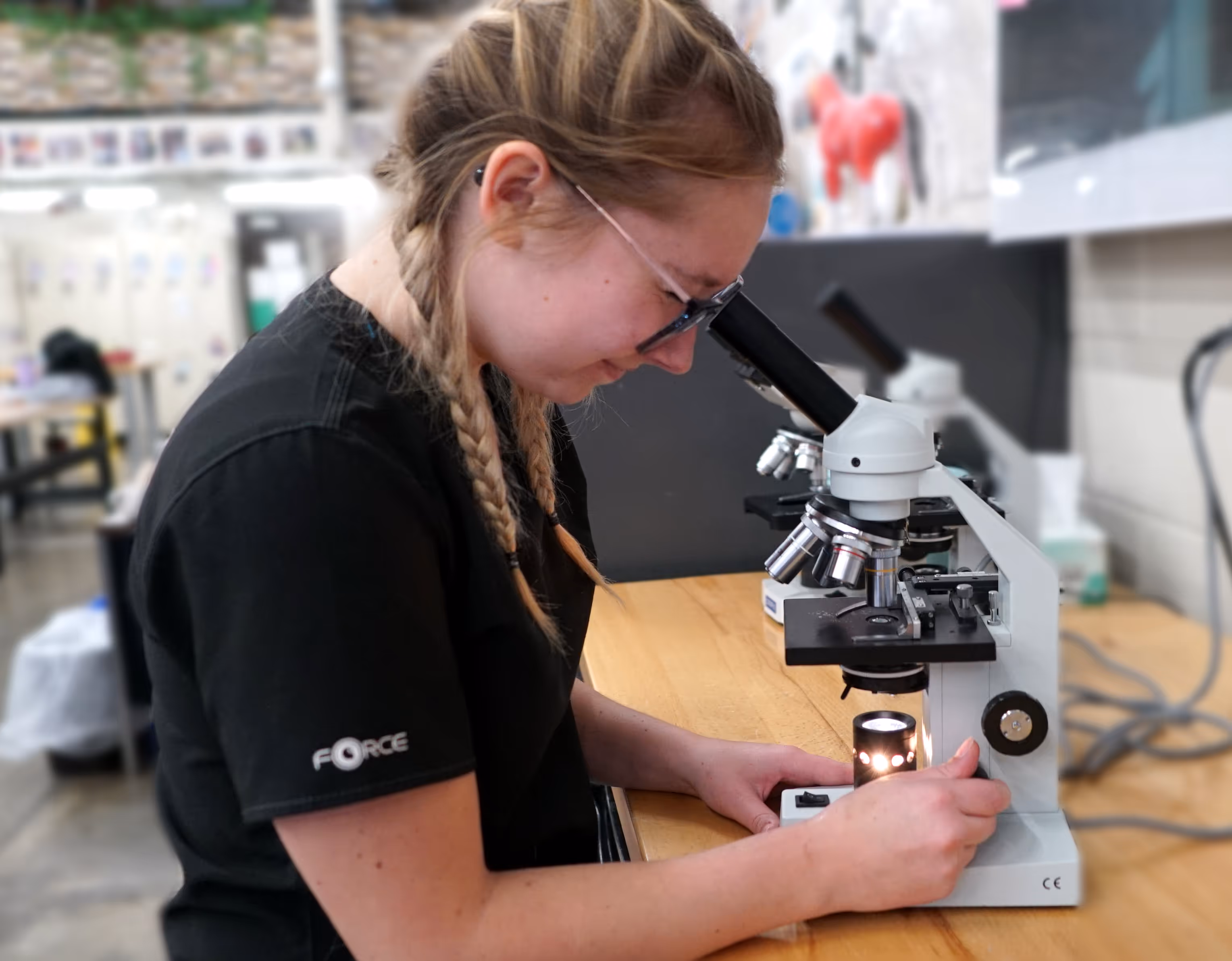 Student looking in microscope
