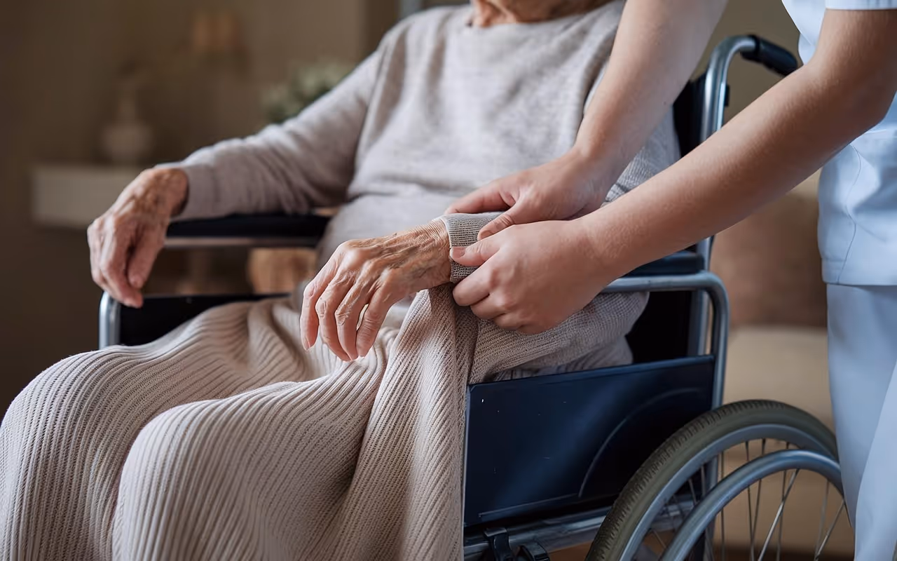 Person in wheel chair being assisted by nurse