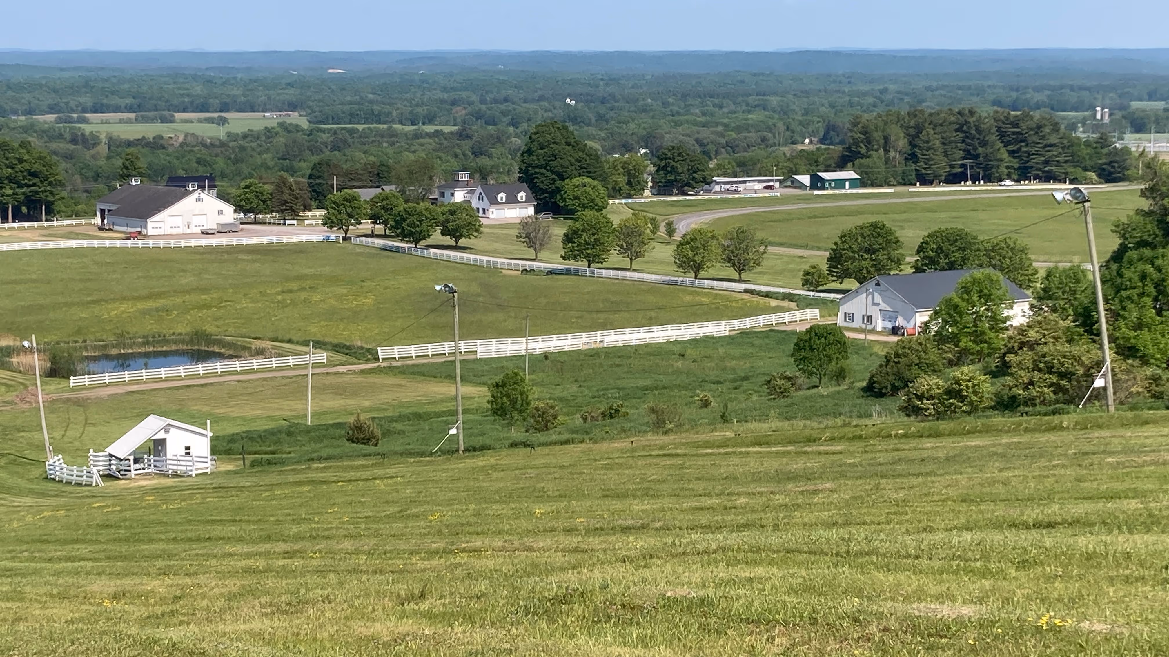 View of the overall property in spring season.  View of the Adirondacks in horizon.